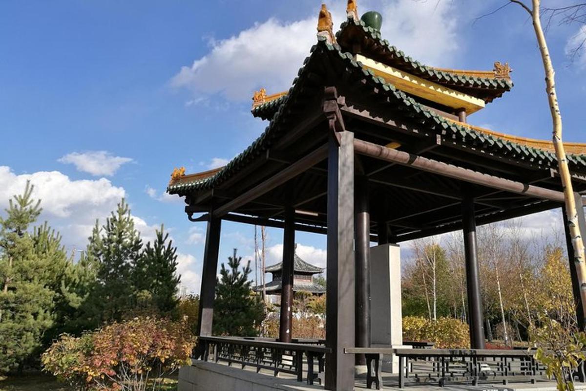 a pagoda in a park with a table and benches