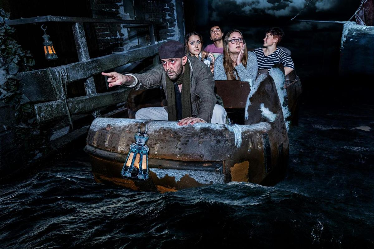 a group of people sitting in a boat in the water