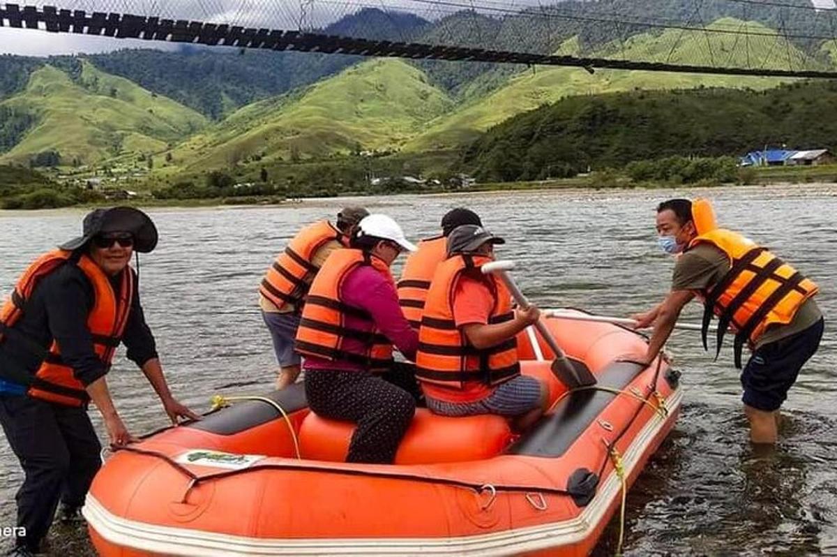 a group of people in an orange raft in the water
