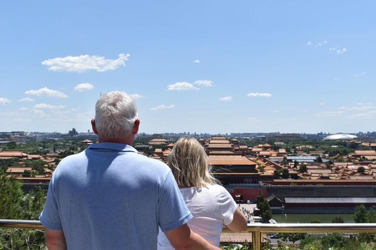a man and woman standing on a balcony looking at a city