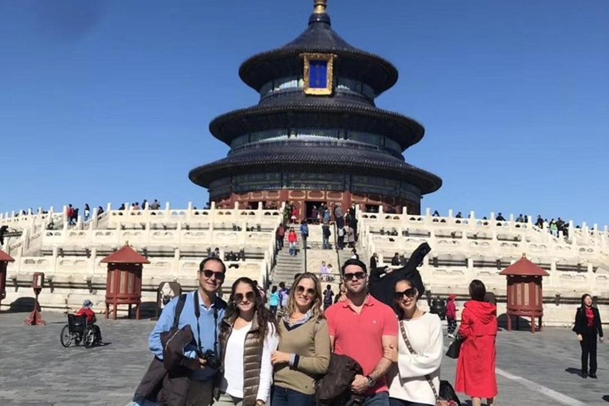 a group of people posing in front of a building