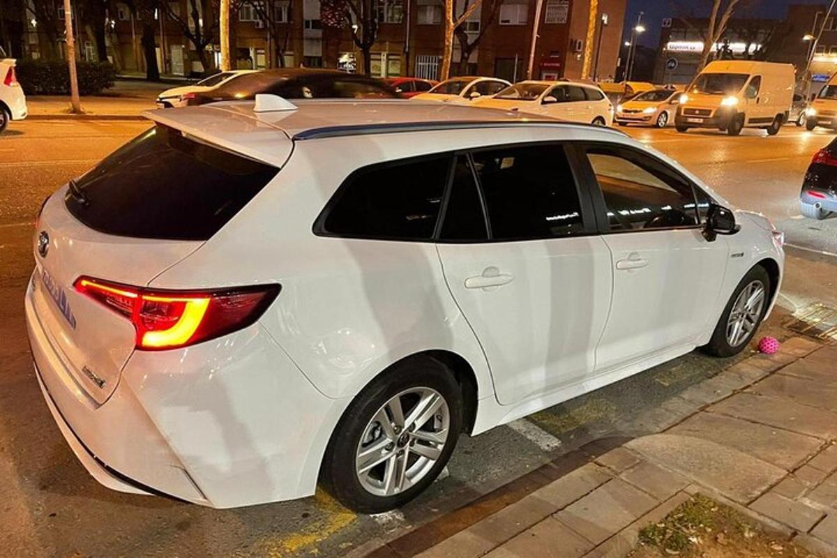 bílé auto zaparkované na kraji ulice