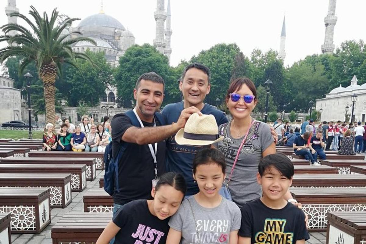 a family poses for a picture in front of a mosque