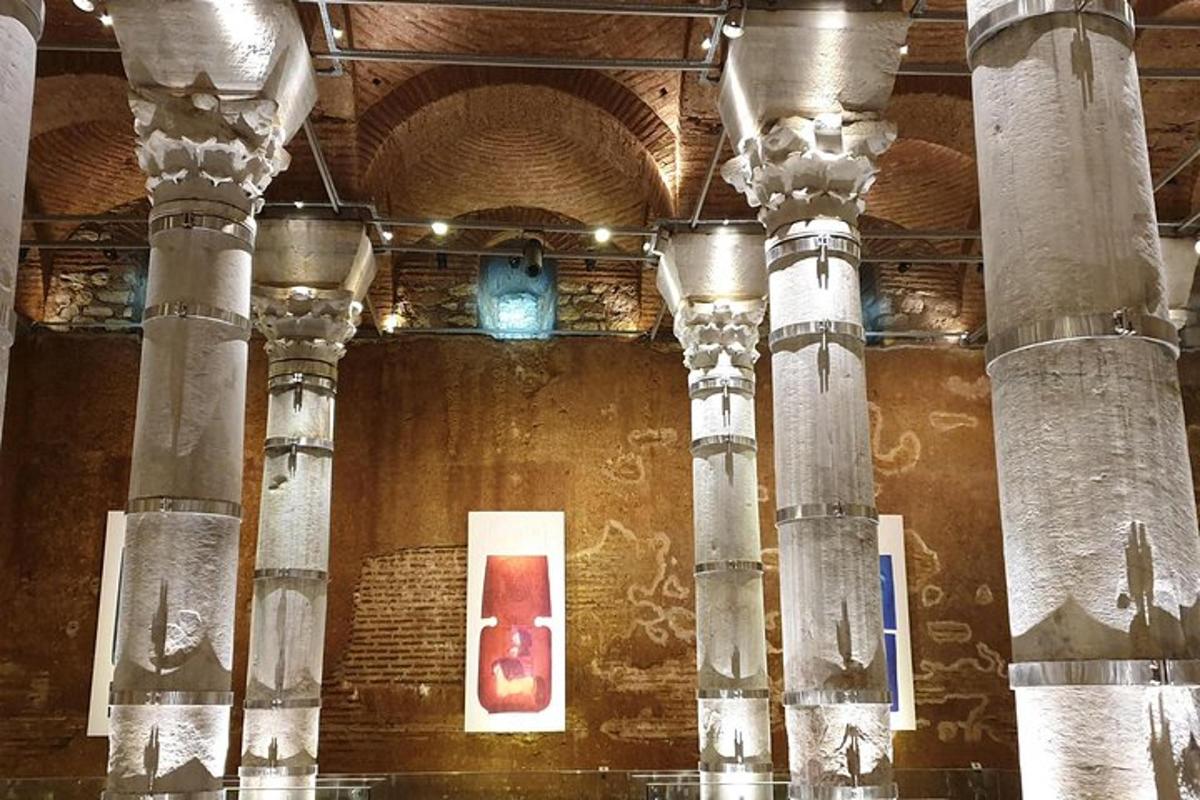 a building with columns and a painting on the wall