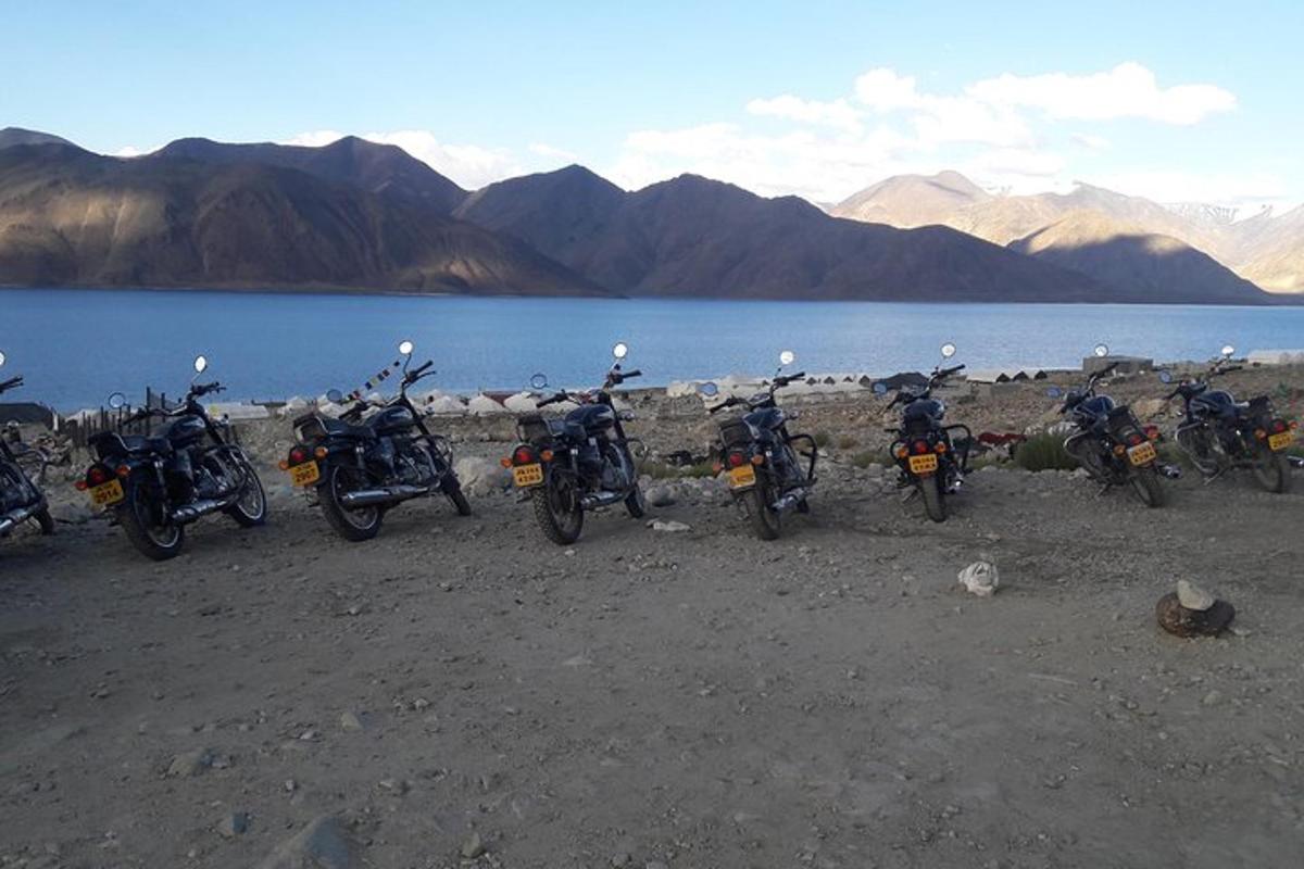 a group of motorcycles parked next to a body of water