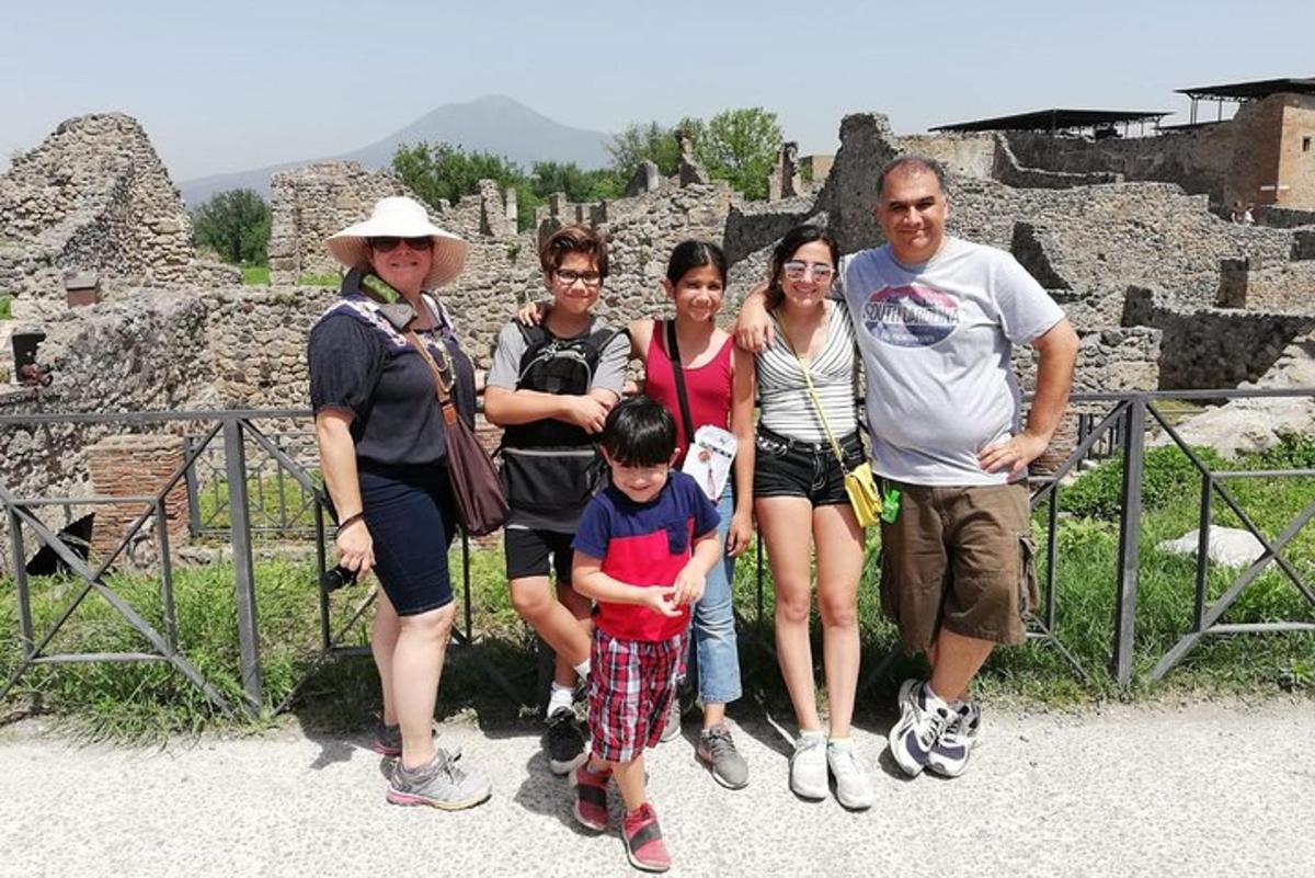 a group of people posing for a picture at the ruins