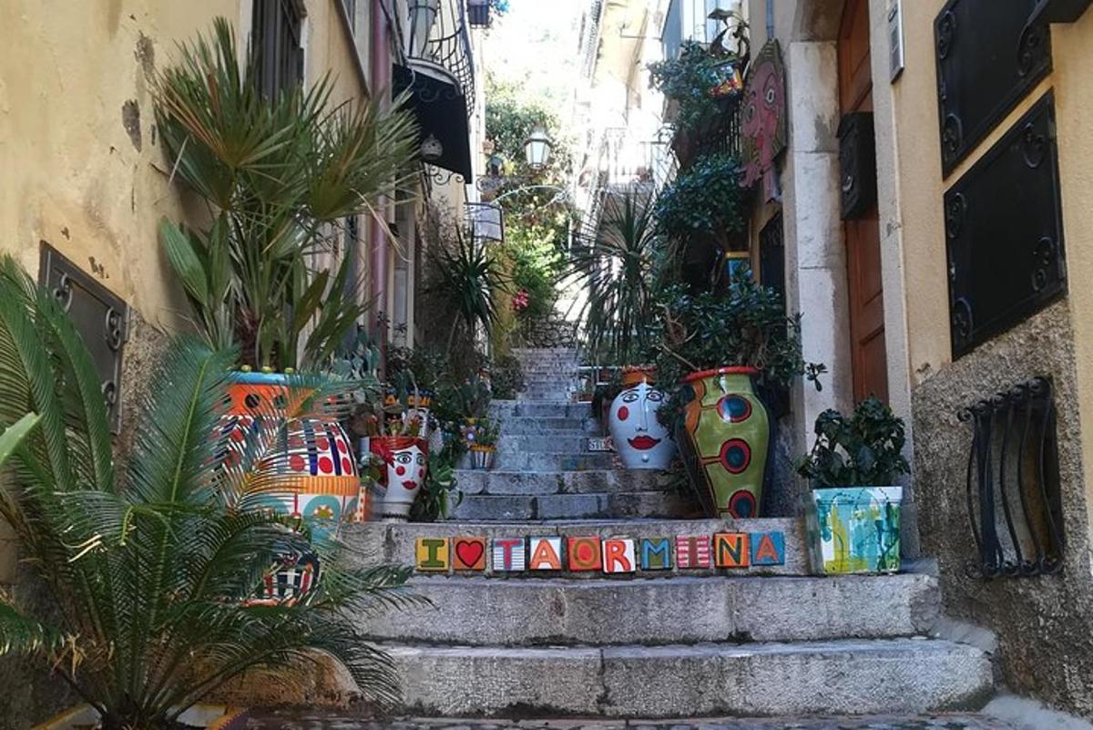 a set of stairs with plants and vases on them