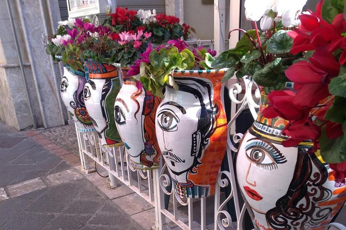 a row of vases filled with flowers on a rack
