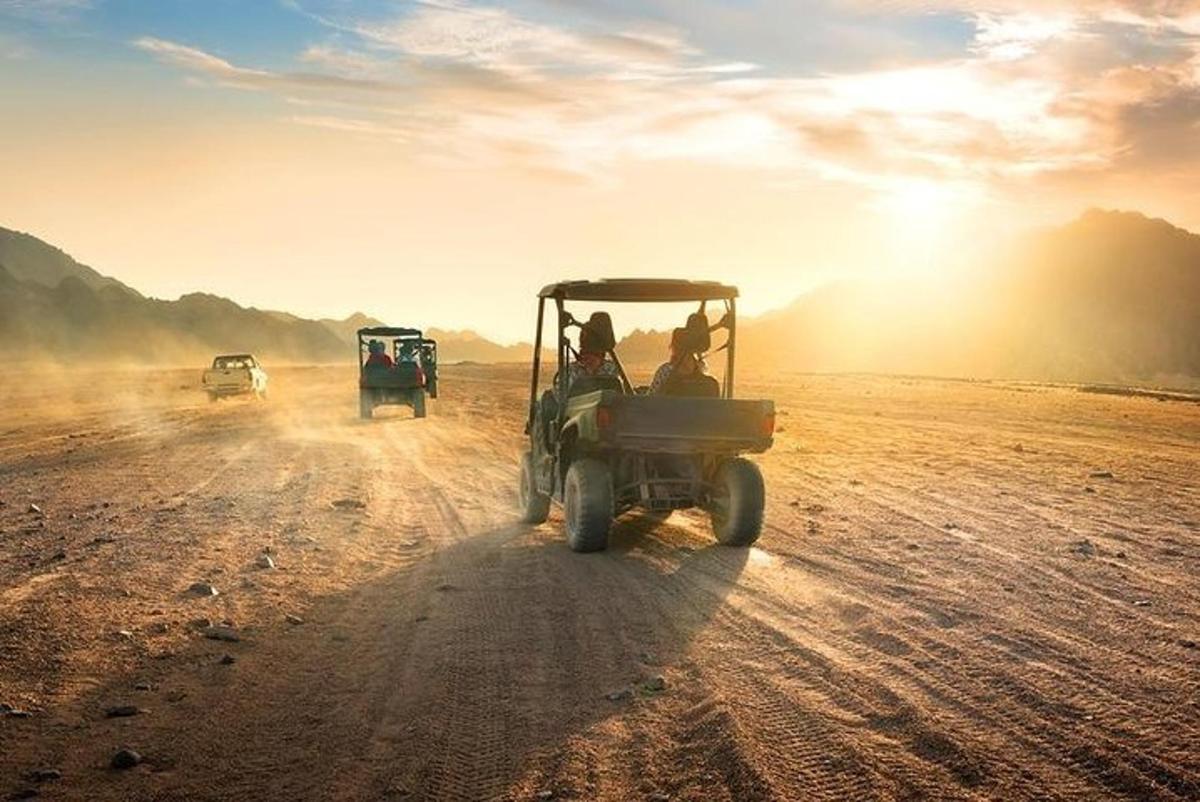 a group of people in a vehicle on a dirt road