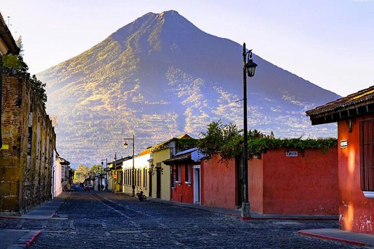 a mountain in the background of a street with buildings