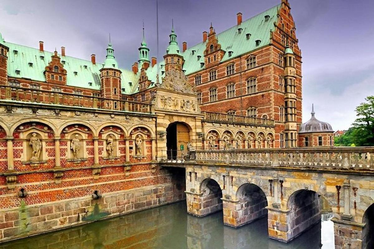 a large brick building with a bridge in the water