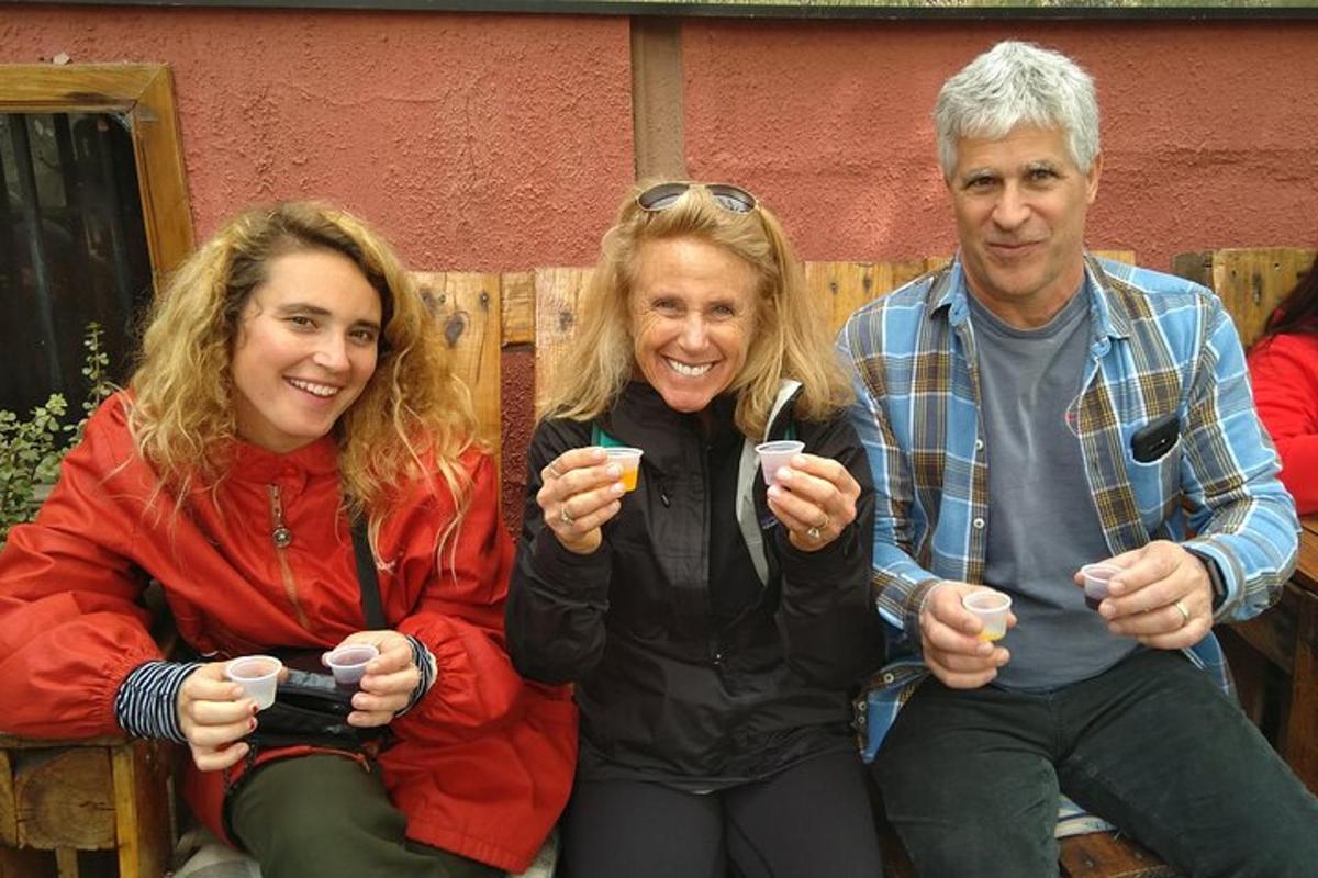 three people sitting on a bench posing for a picture
