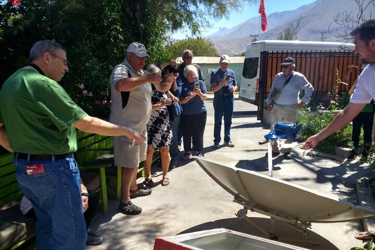 a man standing next to a boat in front of a group of people