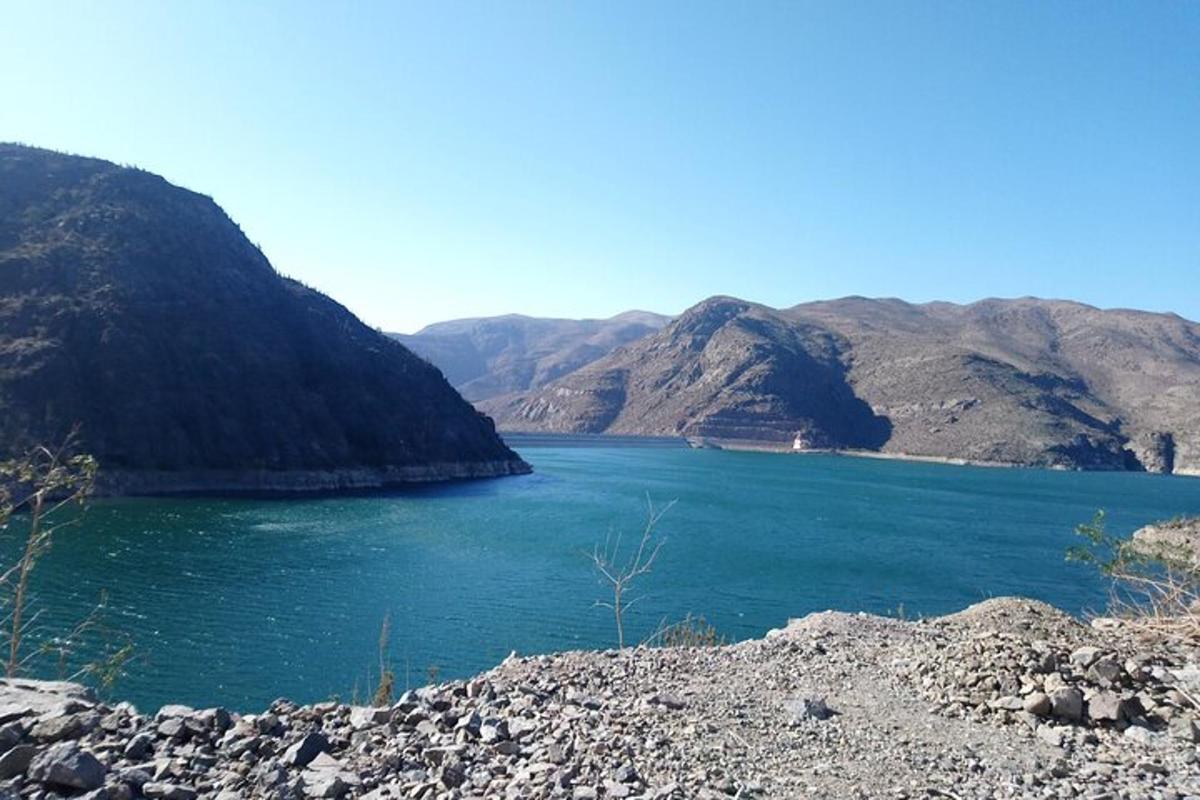 a body of water with mountains in the background