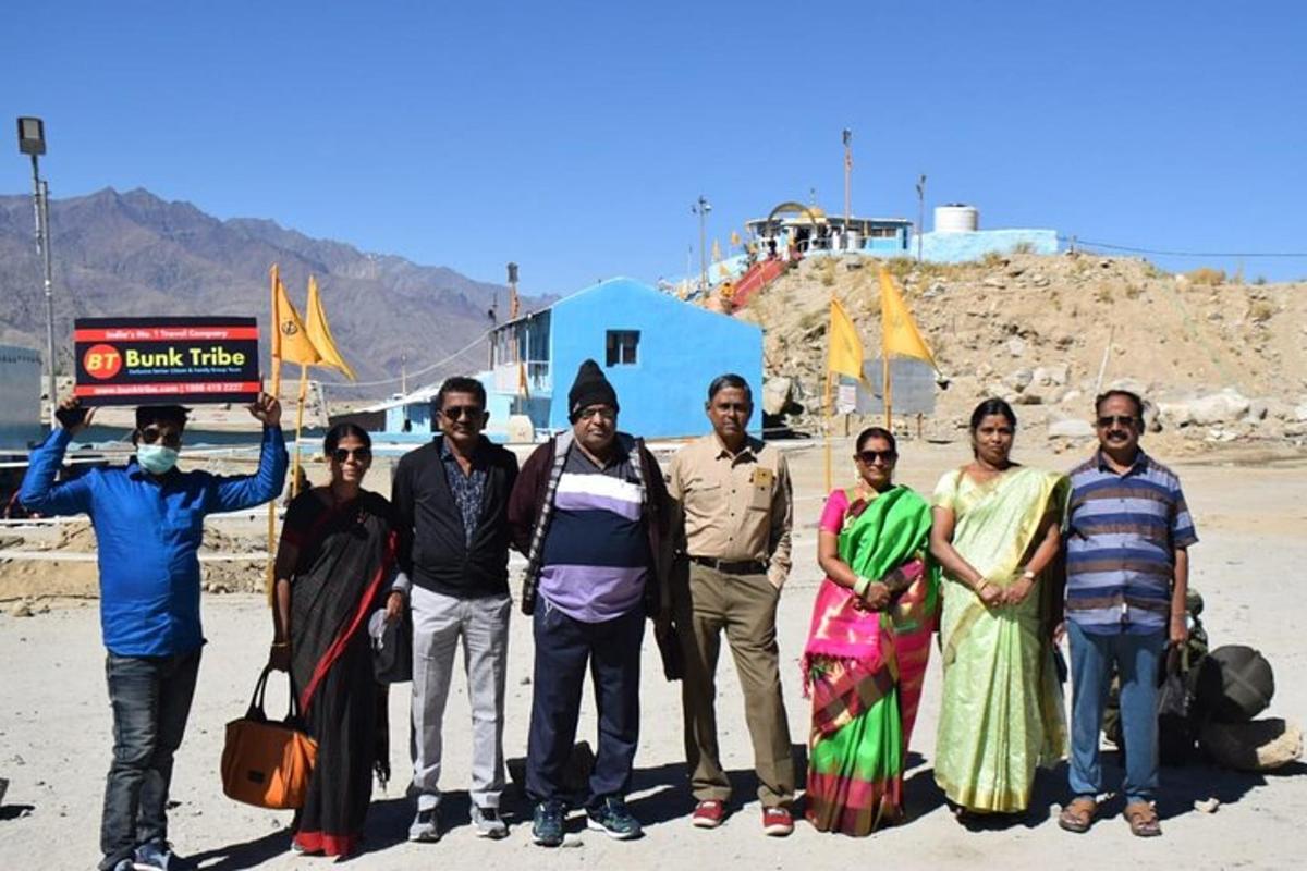 a group of people posing for a picture on the beach