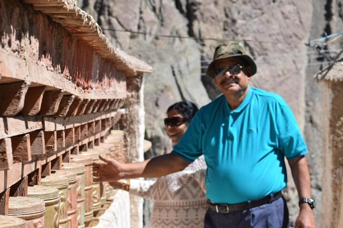 two men are standing next to a building