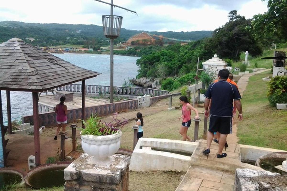 a group of people standing near the water