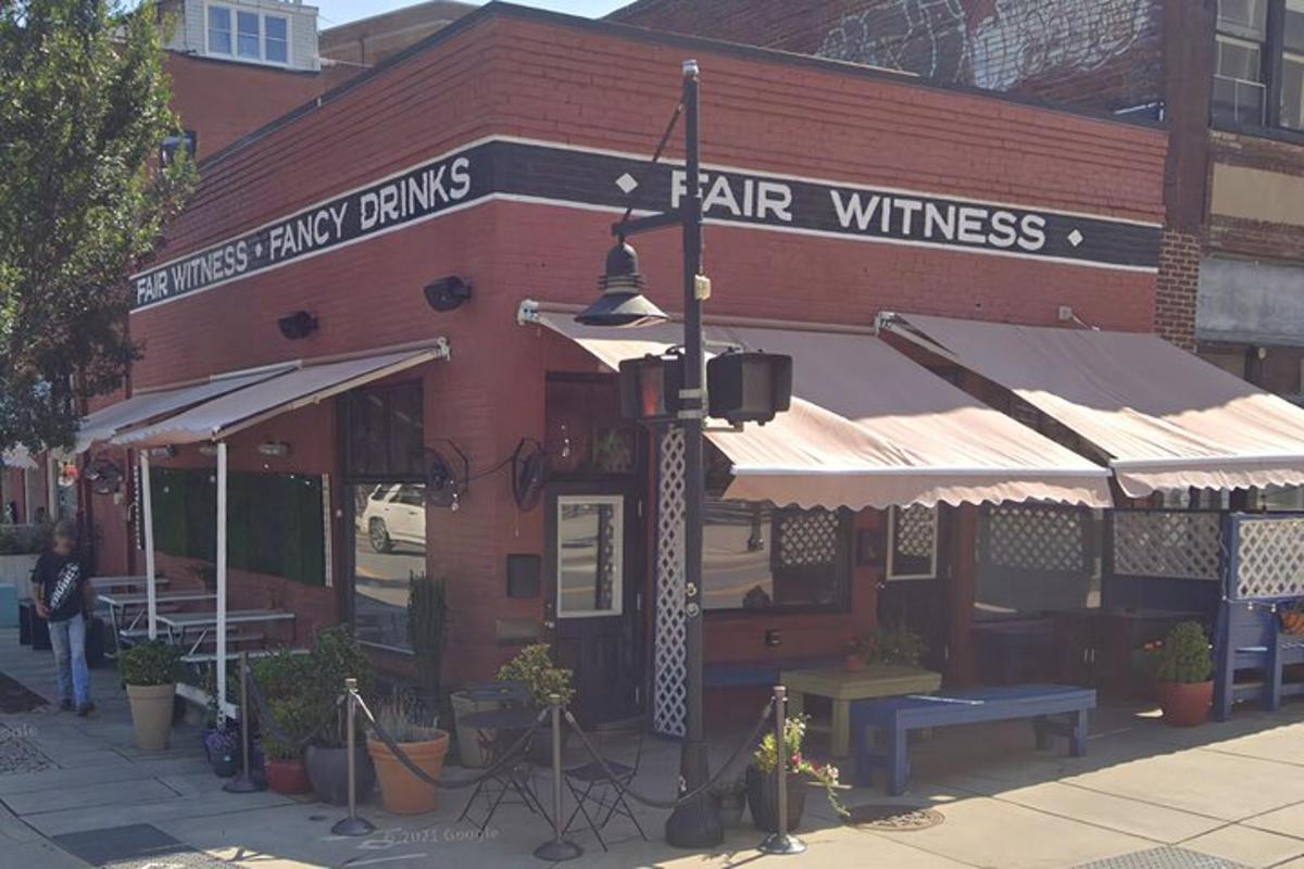 a large red brick building with a restaurant with a sign