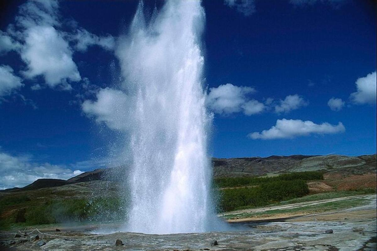 a large waterfall in the middle of a field