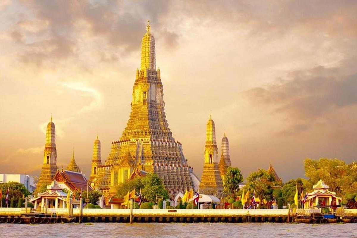 a large building with tall towers next to the water