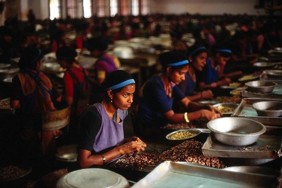 a group of women standing in a kitchen preparing food