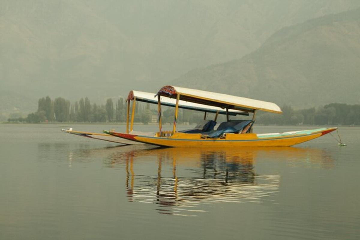 a yellow boat floating on the water in a lake