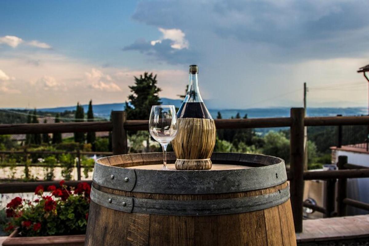 a glass of wine sitting on top of a barrel