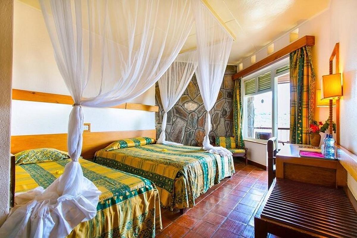una habitació d'hotel amb dos llits i una finestra