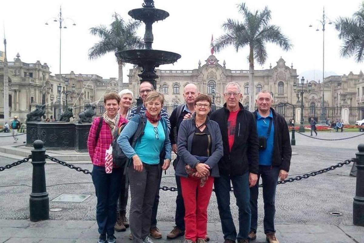 a group of people standing in front of a fountain