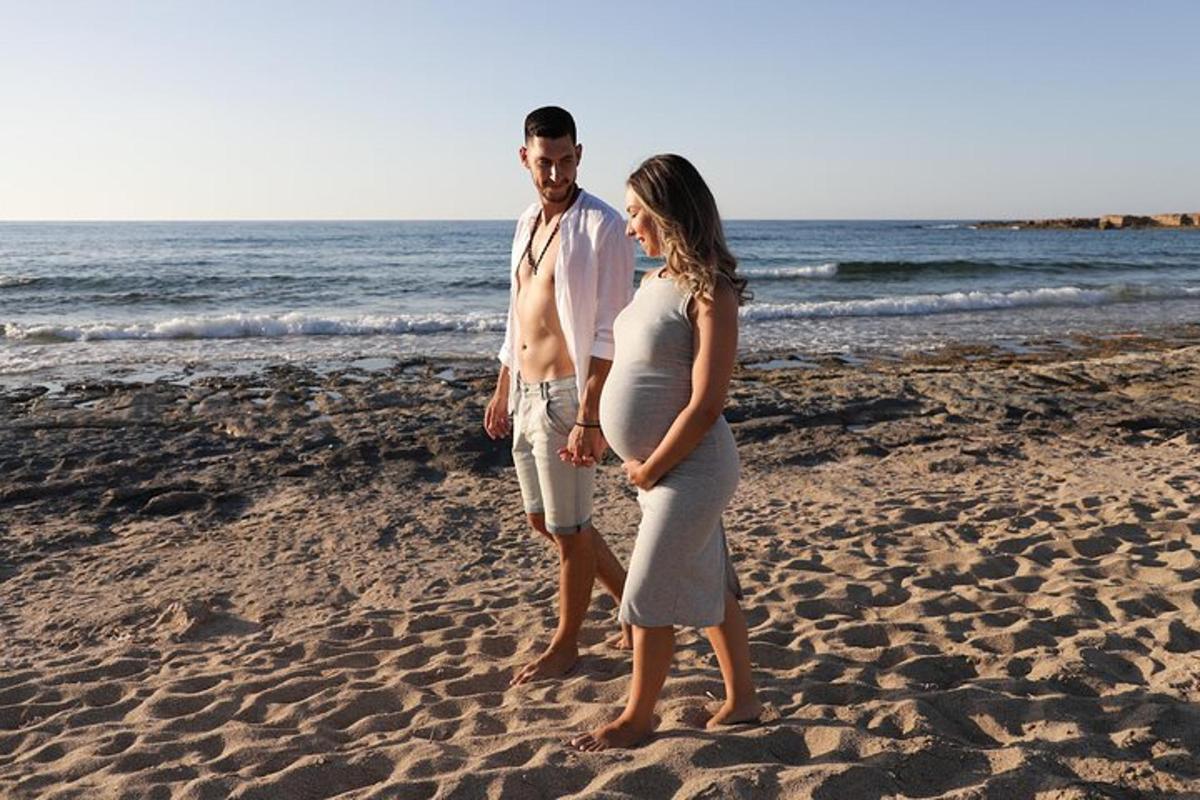 a man and a woman standing on the beach