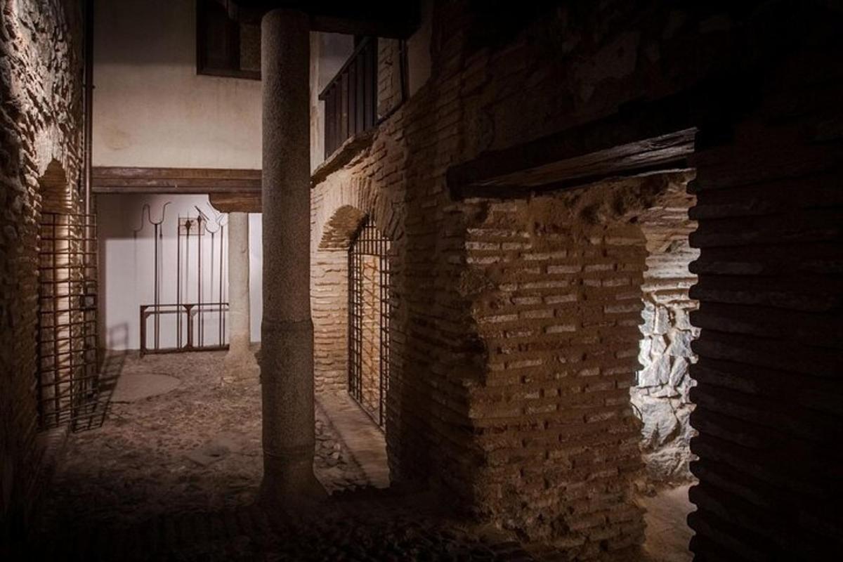 an old brick building with a gate in an alley
