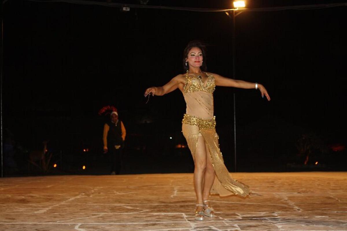 a woman in a dress dancing on a runway