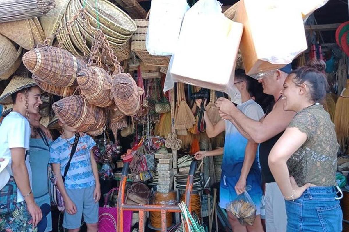 a group of people standing around a market with baskets