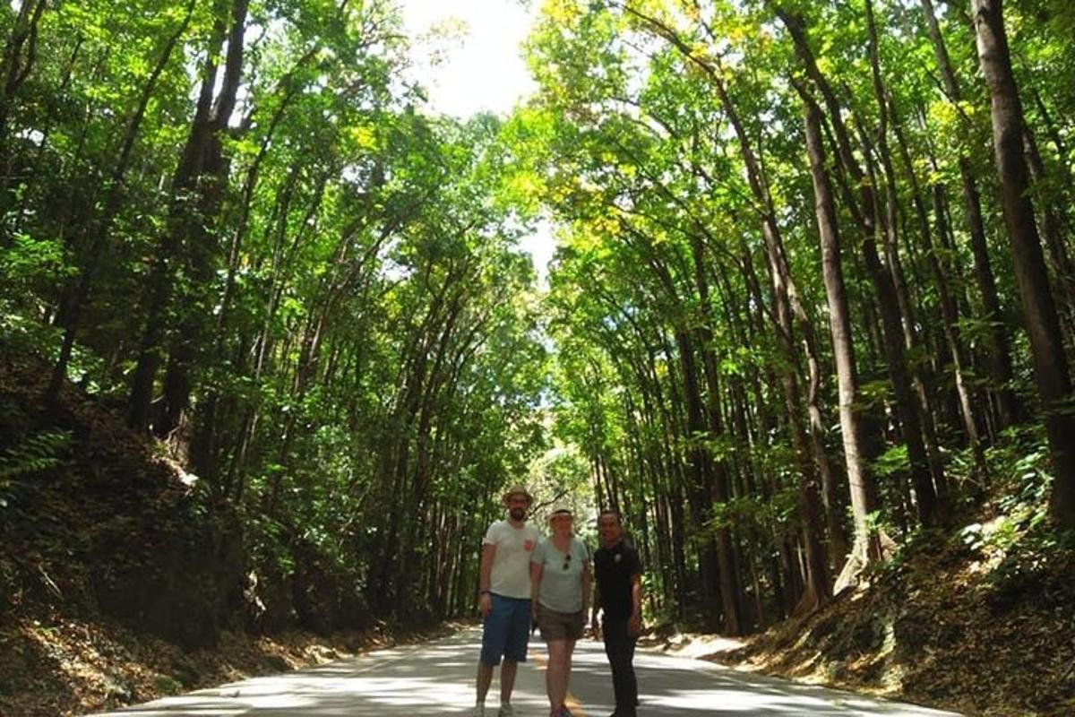 a group of three men standing on a road