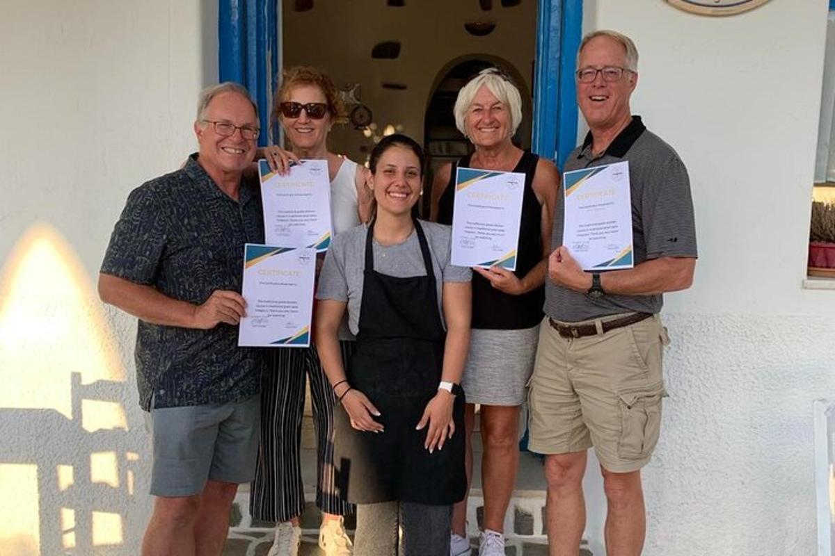 a group of people posing for a picture holding certificates