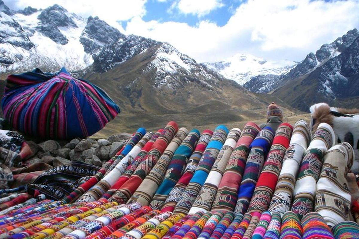 a pile of colorful pipes with mountains in the background