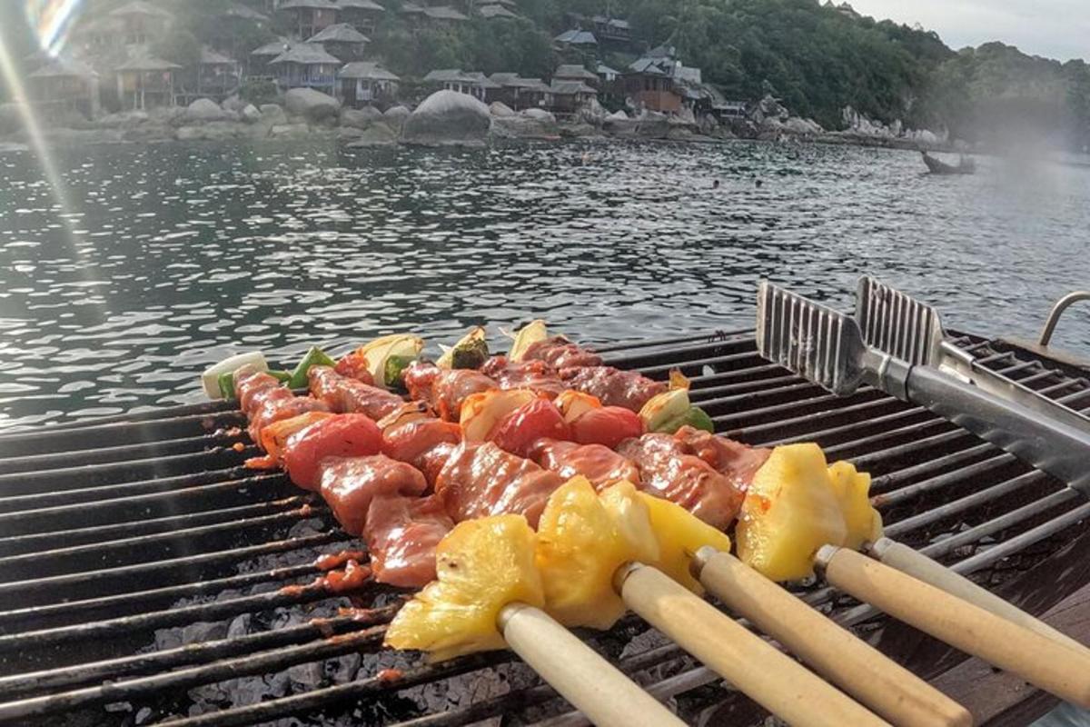 a bunch of food on a grill on the water
