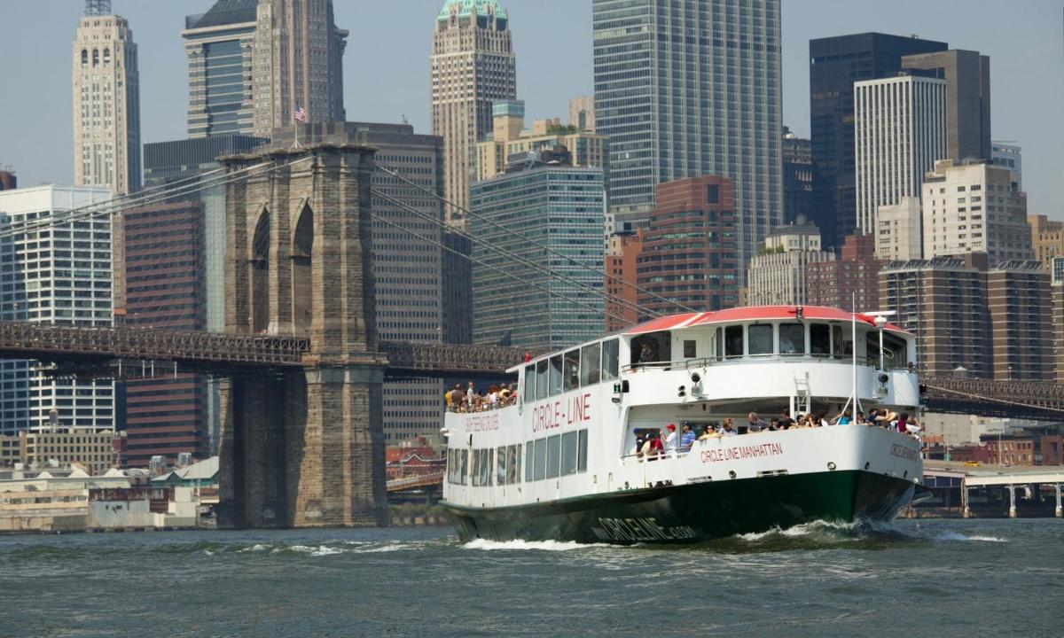 a boat on the water in front of a bridge