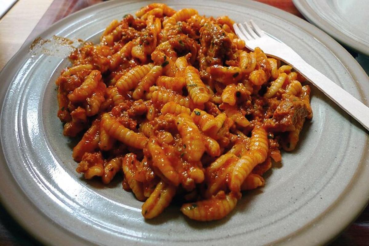 a plate of pasta on a table with a fork