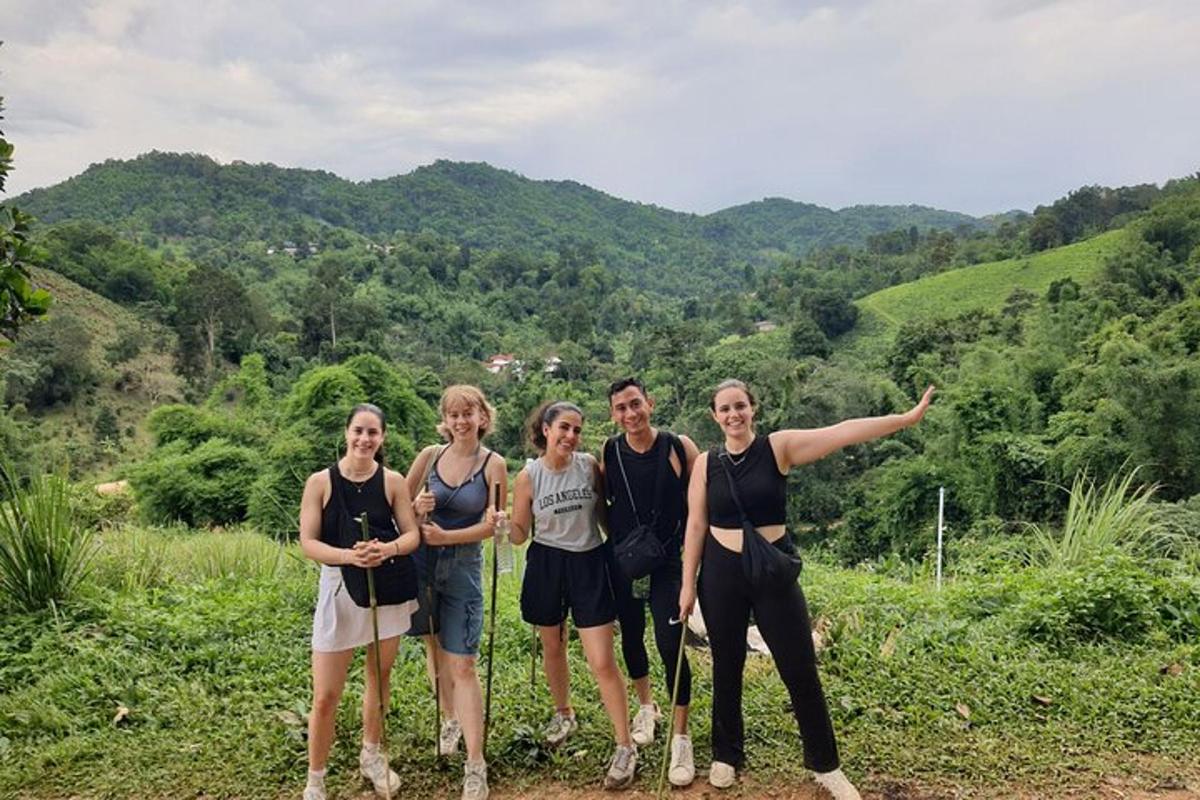 a group of people posing for a picture on a mountain