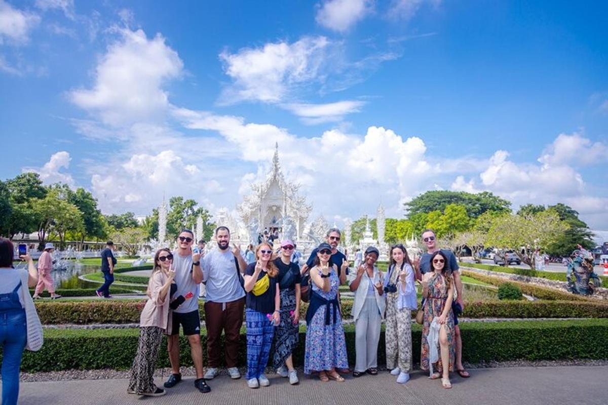 a group of people posing for a picture in front of a building