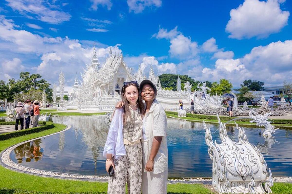 two women standing in front of a fountain