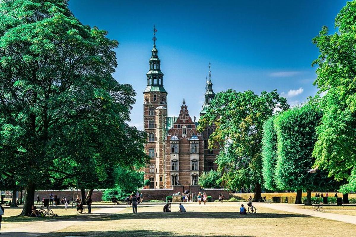 a large building with a clock tower in a park