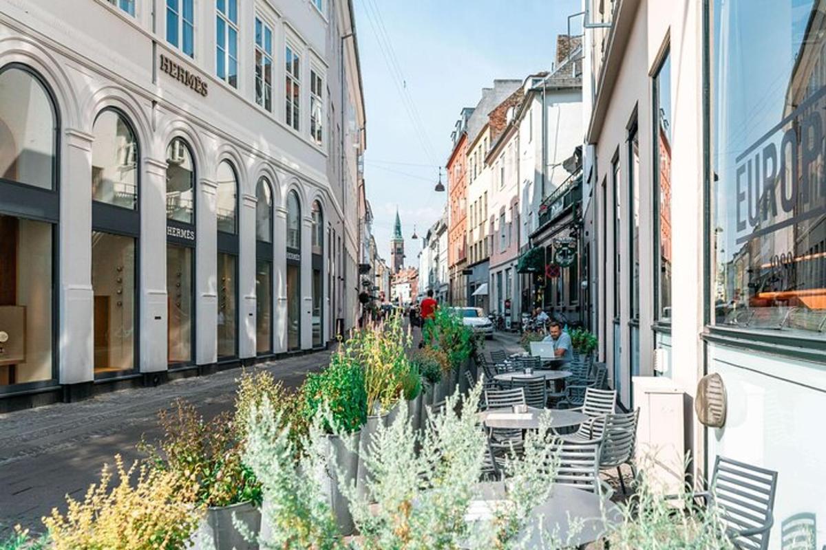 a city street with tables and chairs and buildings