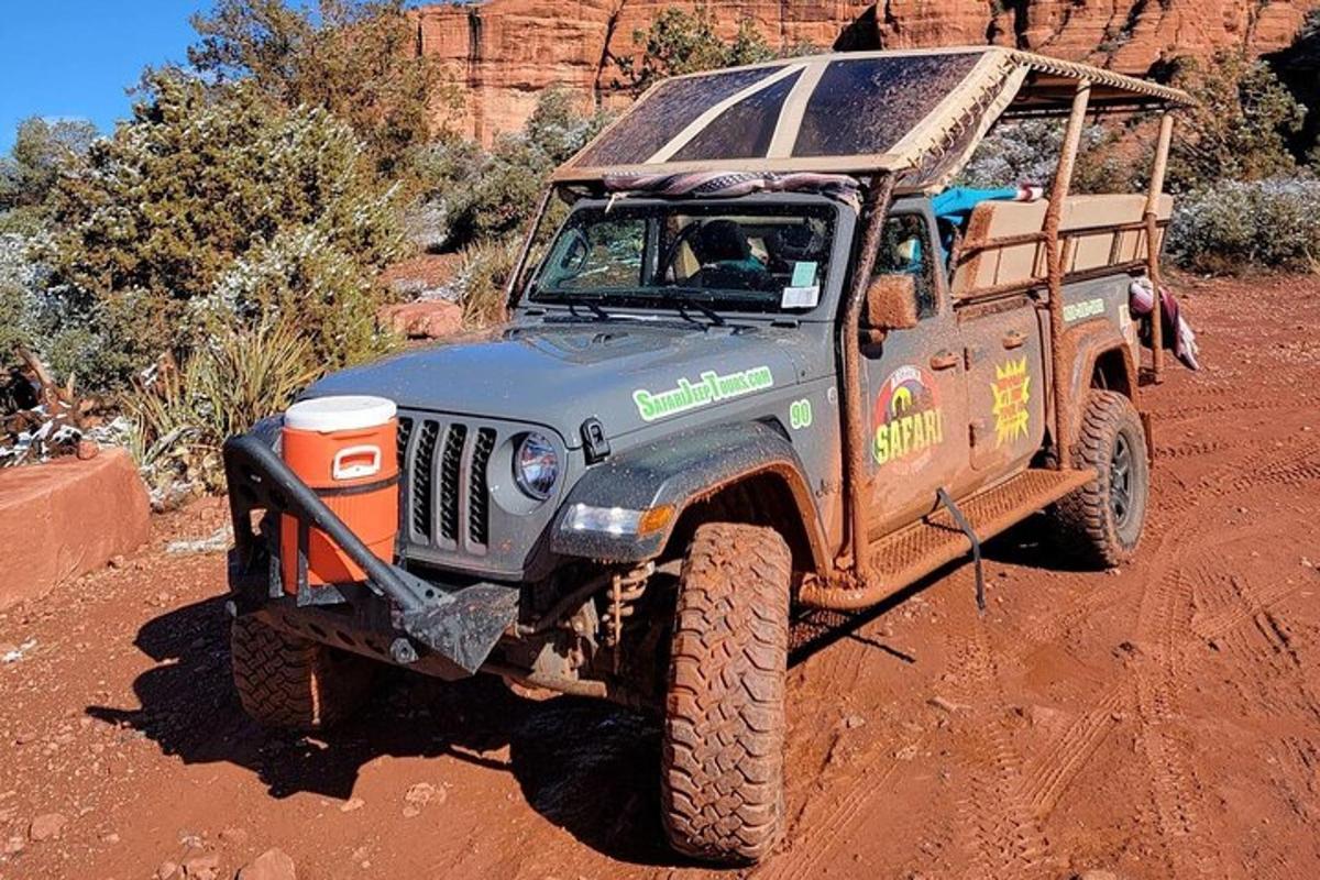 a jeep driving on a dirt road in the desert