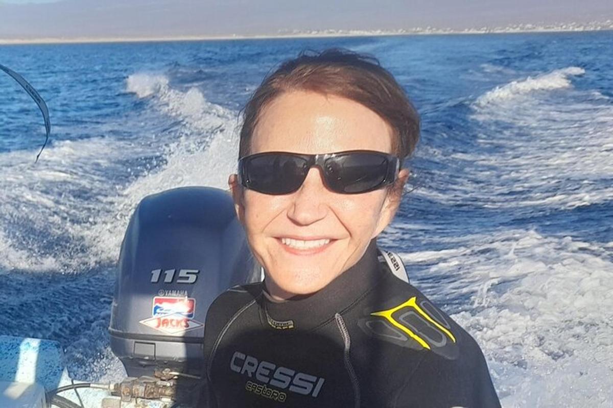 a woman wearing sunglasses on a boat in the water