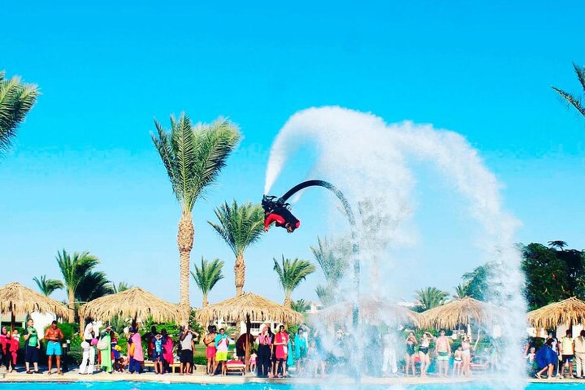 a person doing a trick in front of a fountain