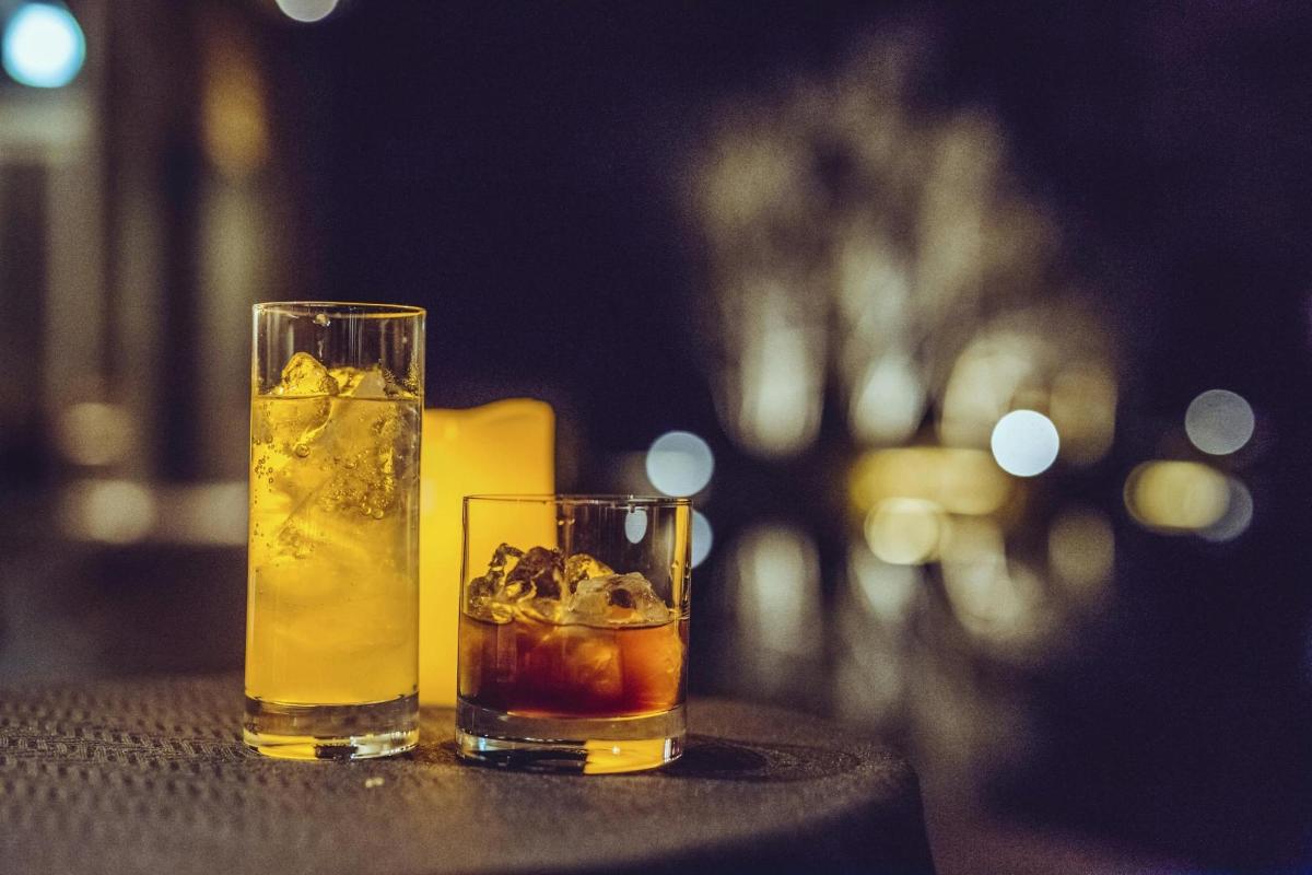 two glasses of drinks sitting on a table