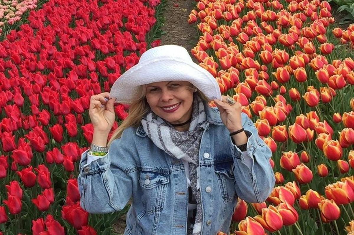 a woman in a hat in a field of tulips