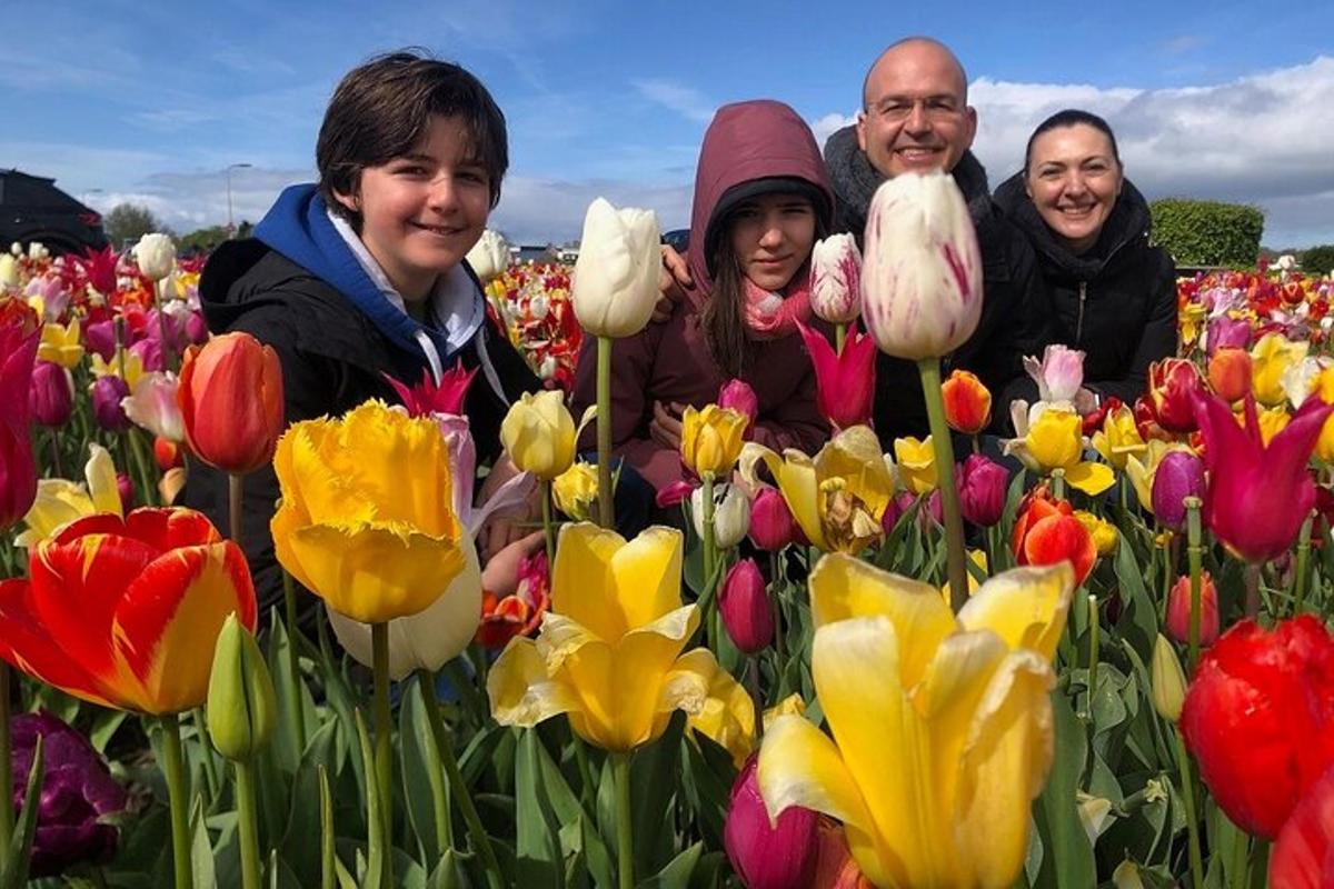 three people standing in a field of flowers